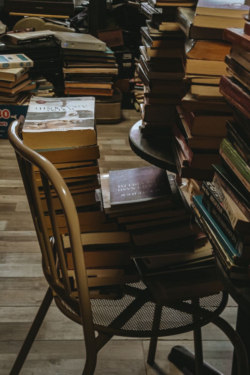 A cluttered yet charming secondhand book store filled with piles of used books.
